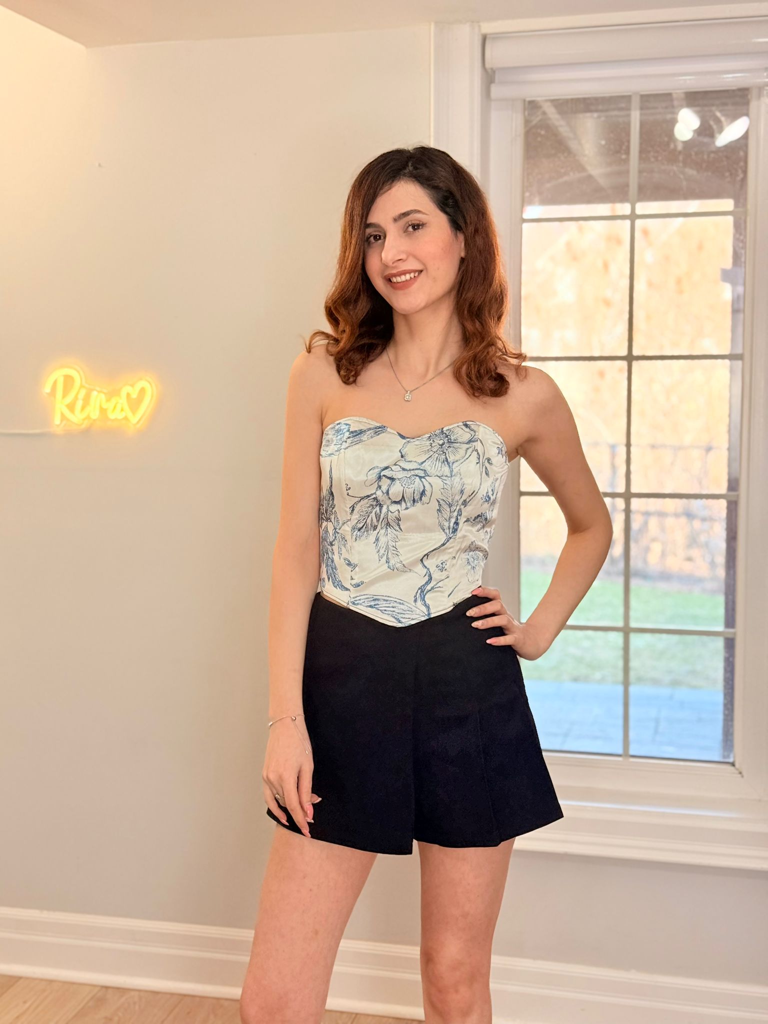 Blue floral satin corset top with delicate pattern and structured boning