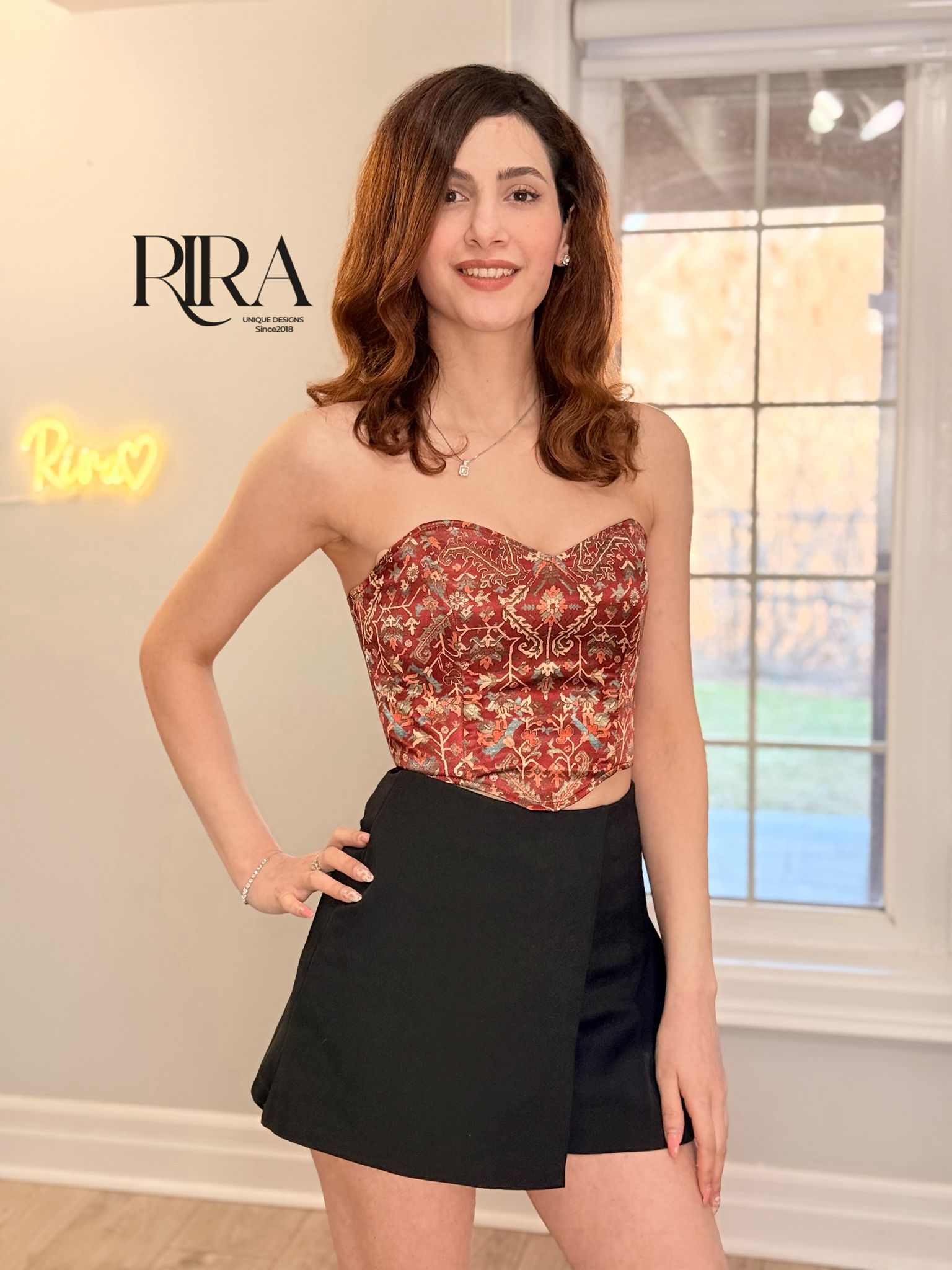 Red Persian carpet corset top with rich pattern and structured satin design